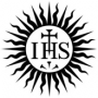 A Christogram with the letters IHS plus a cross and nails, enclosed in a sun burst.