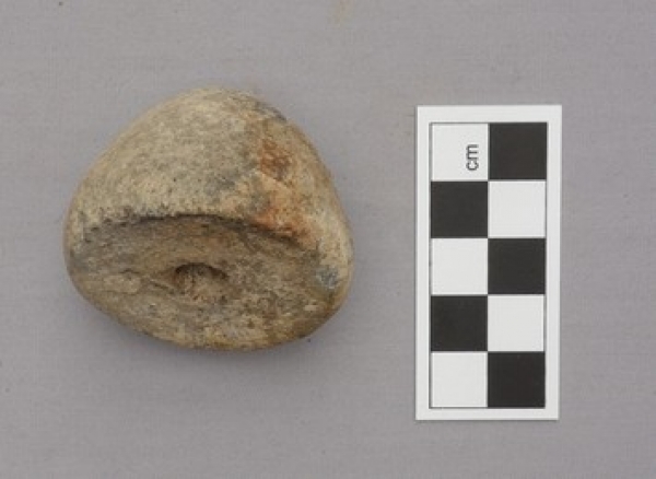 Early Bronze Age spindle whorl from Greece, made of clay.