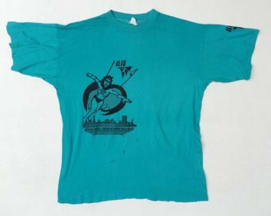 Turquoise T-shirt with a black image of a super heroine and the initials ILIS (International Lesbian Information Service).