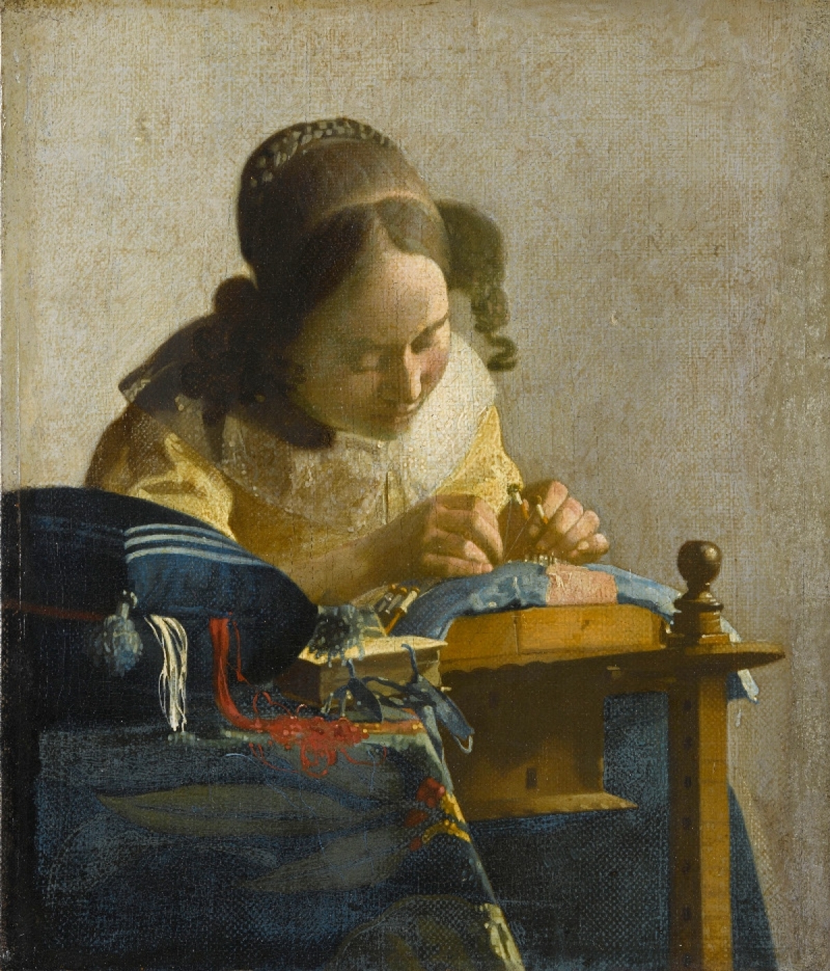 Johannes Vermeer, De Kantwerkster (&#039;The Lacemaker&#039;),  c. 1670. Woman working bobbin lace. The Louvre, Paris.