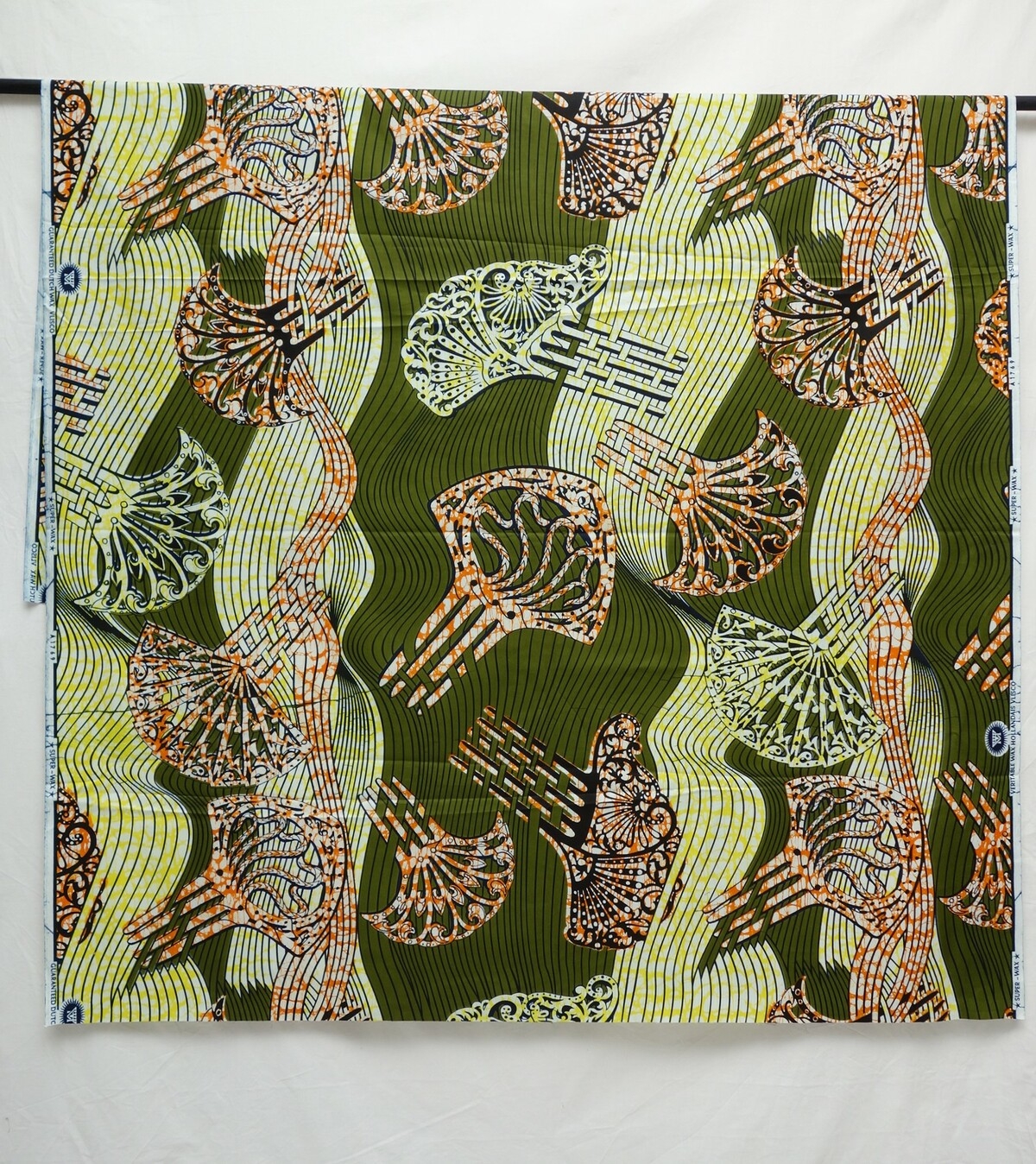 Vlisco cloth with a design of Indonesian-style hairpins on a green ground, early 21st century.