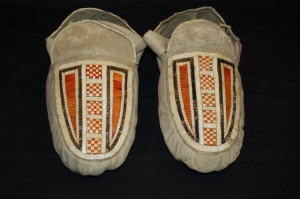 Pair of Esquimeaux Indian moccasins decorated with black, red and white porcupine quill work on the vamp. Acquired from the Hudson's Bay Company (early 19th century).