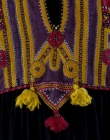 Detail of a dress, Pakistan, 19th century, with triangular amuletic shape hanging down from the waistband.