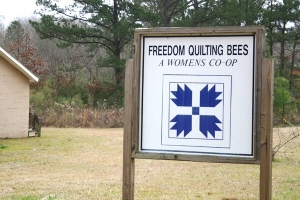 Freedom Quilting Bee sign, showing the Civil Rights emblem.