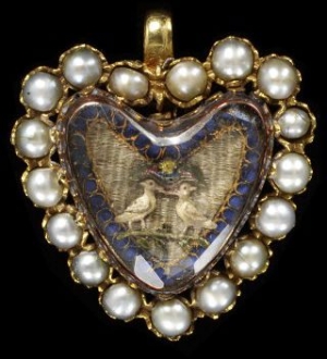 Gold pendant with a border of half pearls surrounding an embroidery under faceted crystal, c. 1700, England.