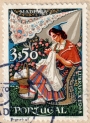 Portuguese postage stamp showing woman from Madeira working her embroidery, 1968.