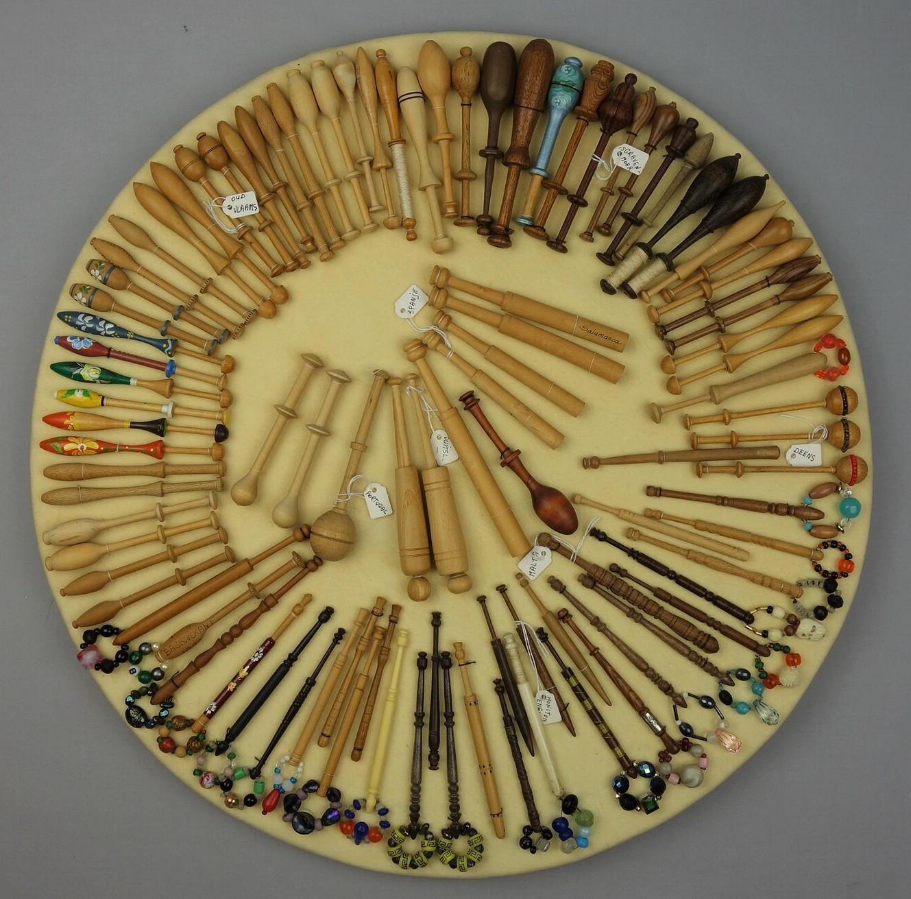 Board with a group of lace bobbins from various countries (TRC 2007.0494).