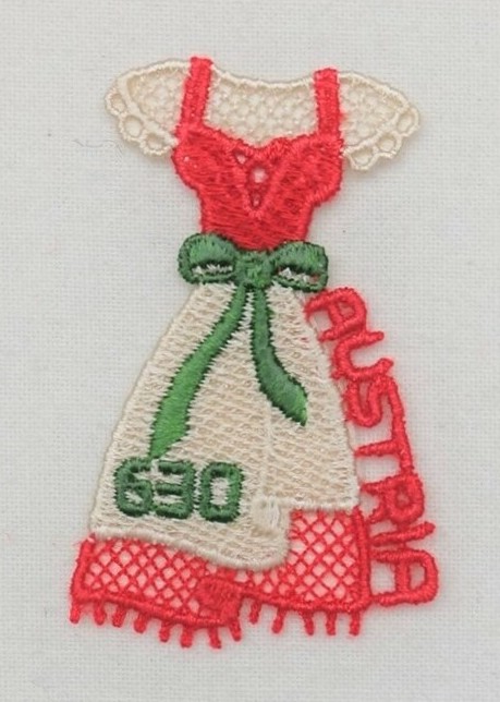 Postage stamp in the form of a dirndl outfit for a woman. The stamp has been machine embroidered. Austria 2016 (TRC 2018.2212).