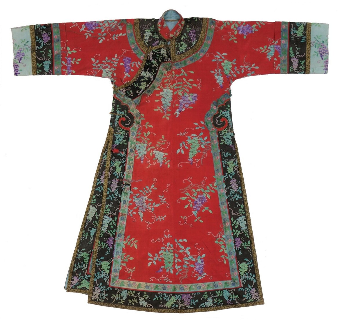 Embroidered woman's gown from China, 19th century (TRC 2018.2840). The gown in made of red silk with a woven design of stylised flowers, applied braids with flowers, and applied (woven) panels down the front opening and side slits of the garments.