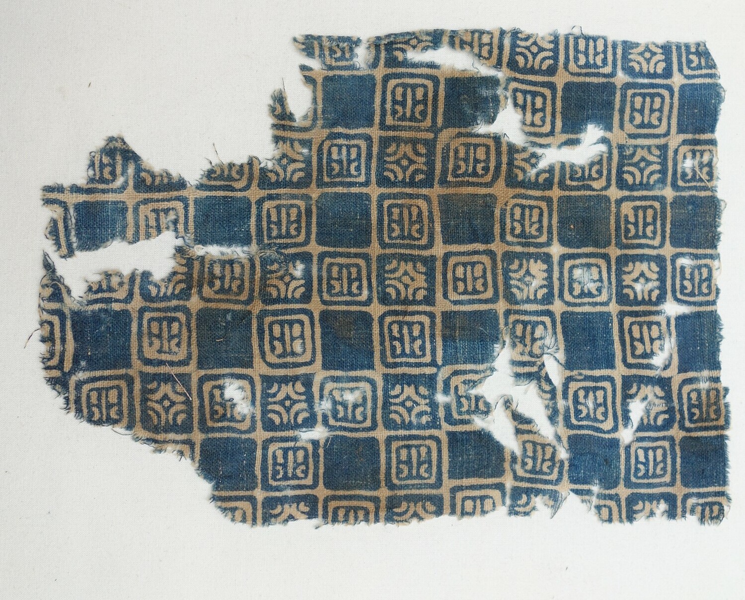 Fragment of a block printed textile using a resist technique, 14th century, from India, excavated at Quseir al-Qadim, Red Sea coast, Egypt (TRC 2020.0239).