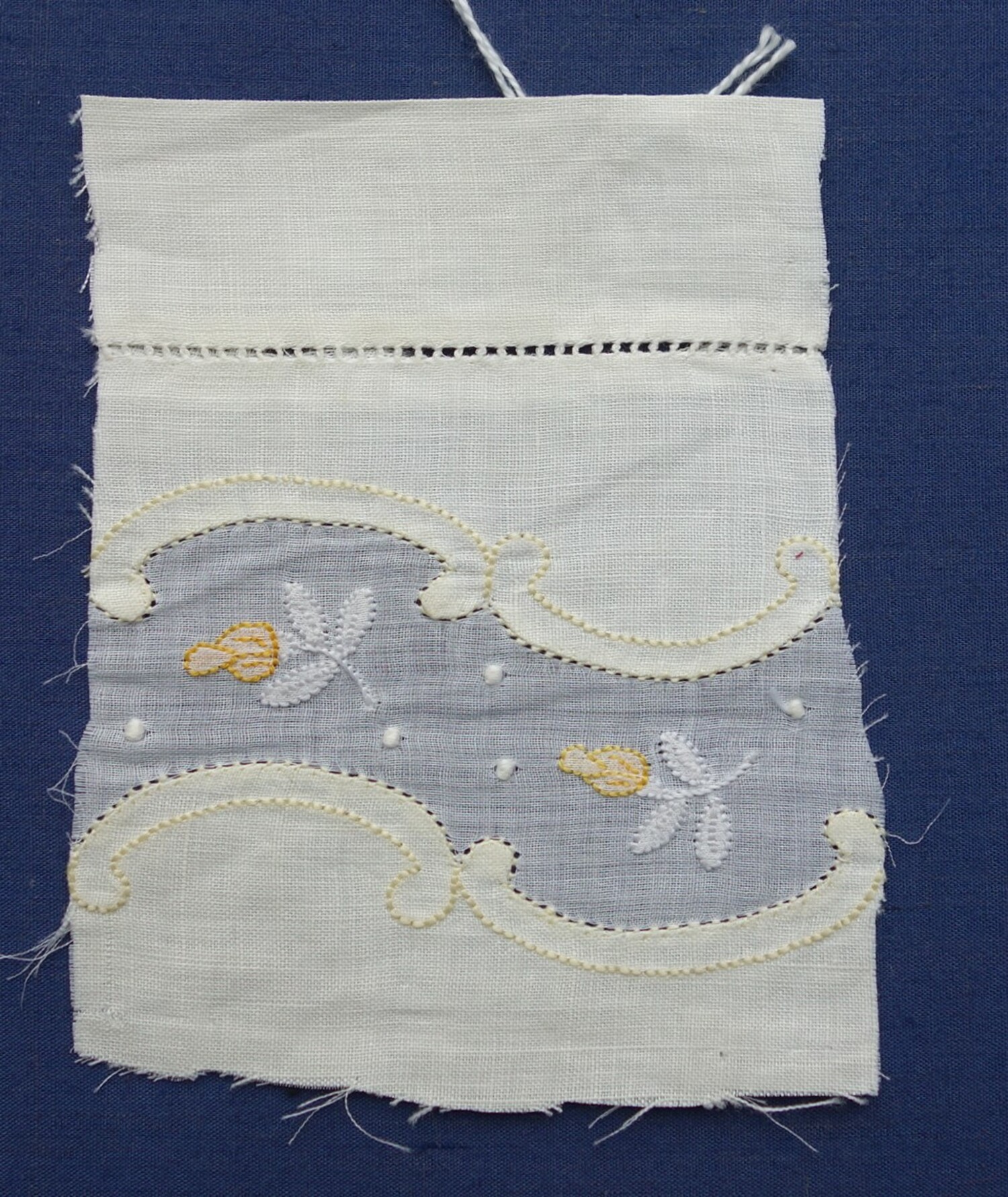 Sample of shadow work on a single layer of cloth flanked by double layers of cloth, Europe, early 20th century (TRC 2021.0846).