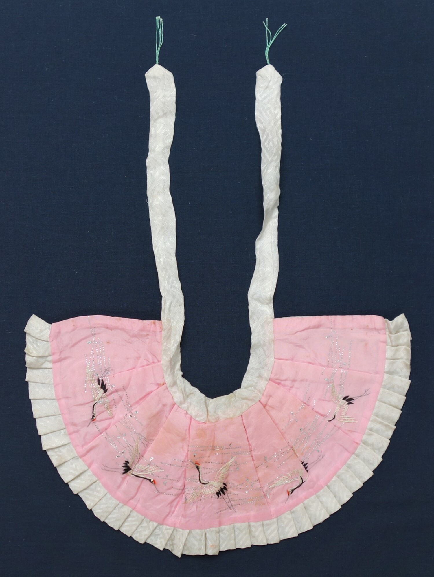 Bib for a baby girl, Japan, 1920s-1940s (TRC 2021.2135a).