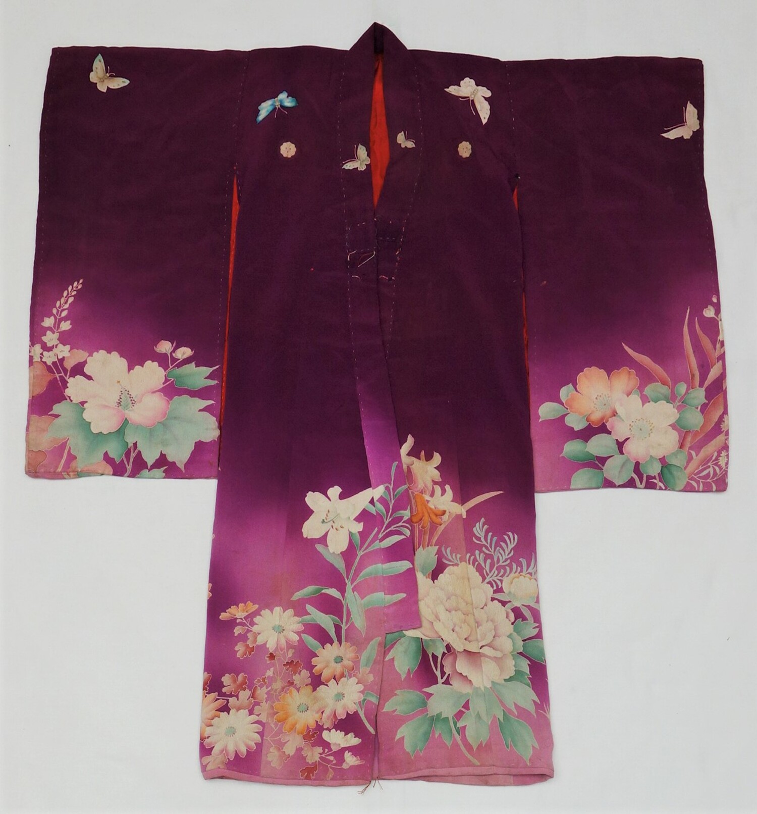 A girl’s kimono decorated with butterflies, flowers and family crests, Japan, 1926 (TRC 2021.2137). This kimono was worn by four girls between the 1920s and the 1940s and also one generation later, in the 1960s.
