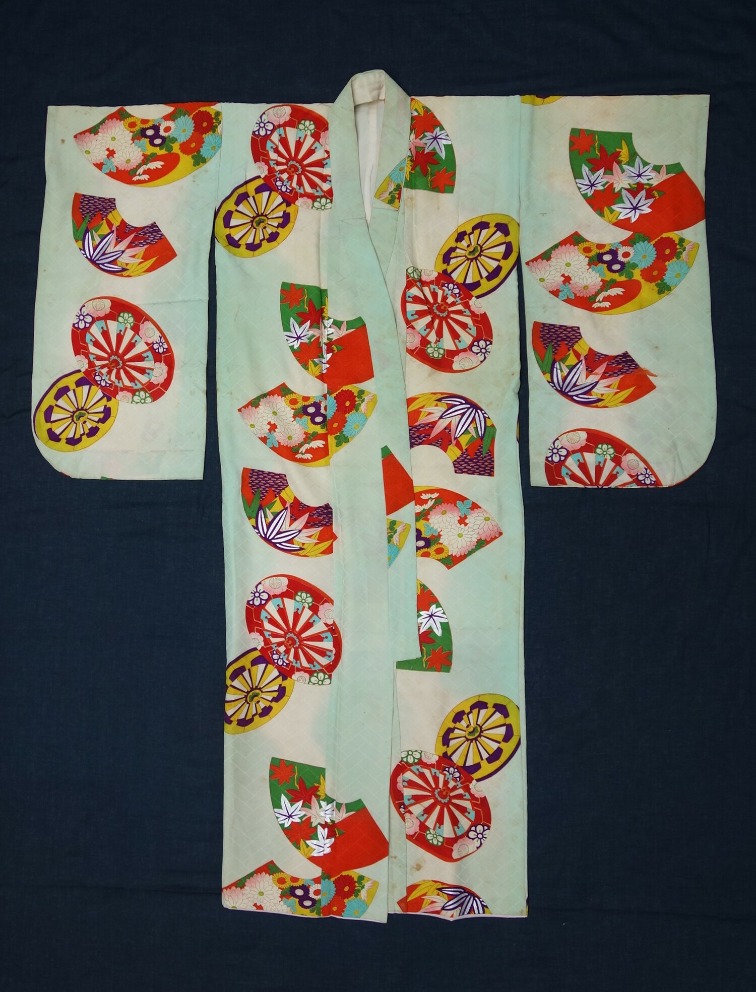 A Schichi-go-san kimono decorated with the wheels of an ox-cart, 1970s, Japan (TRC 2021.2152).