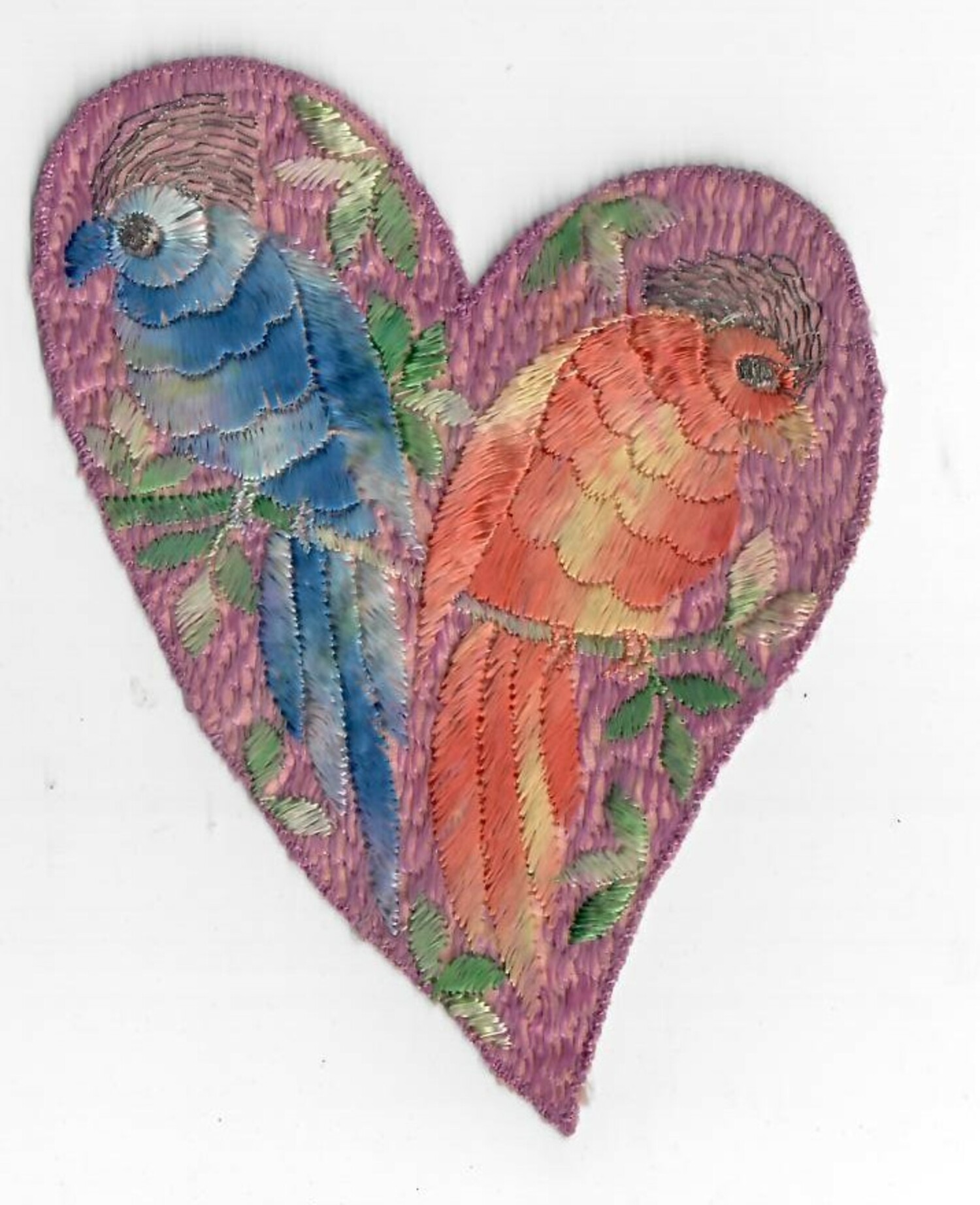 Machine embroidered cigarette silk with a pair of birds, set within a heart. The birds are worked in ombré or shaded threads (1920-1930, TRC 2021.2473h).
