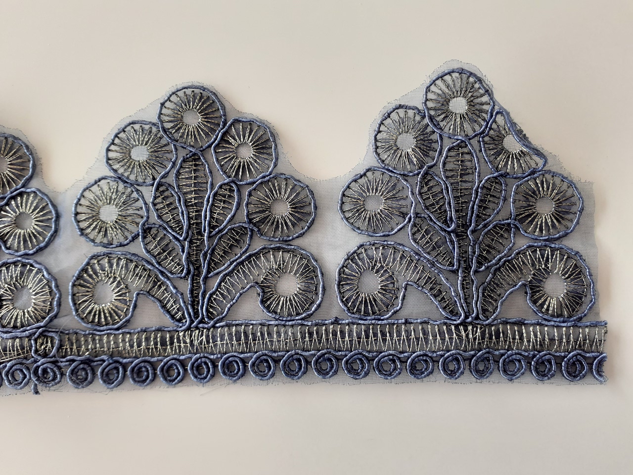 Embroidered band, machine made, for sewing onto garment (jeans?). Private collection.