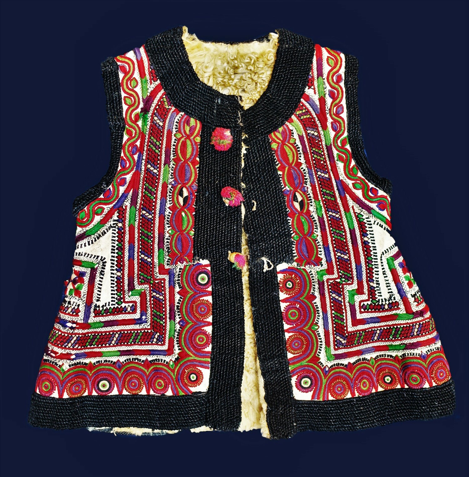 Romanian/Ukrainian waistcoat with white sheep's fleece lining, edged with black looped embroidery. 20th century (TRC 2022.0390).