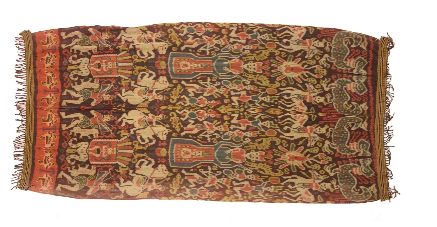 Ikat cloth from East Sumba, Indonesia, 1980-2000, decorated with large-scale human figures, some on horseback, foliage, animals, birds and geometric motifs in white, dark red, red and mid-blue, all on a purplish ground (TRC 2022.0896).