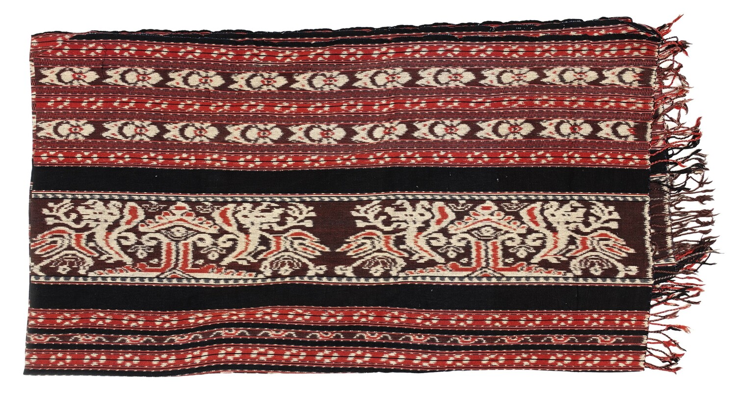 Ikat cloth from Bali (Ubud), Indonesia, 1960-1980, with stripes of varying widths, some in dark blue, others with ikat created stylised floral, foliage and abstract shapes in white, red and blue (TRC 2022.1471).