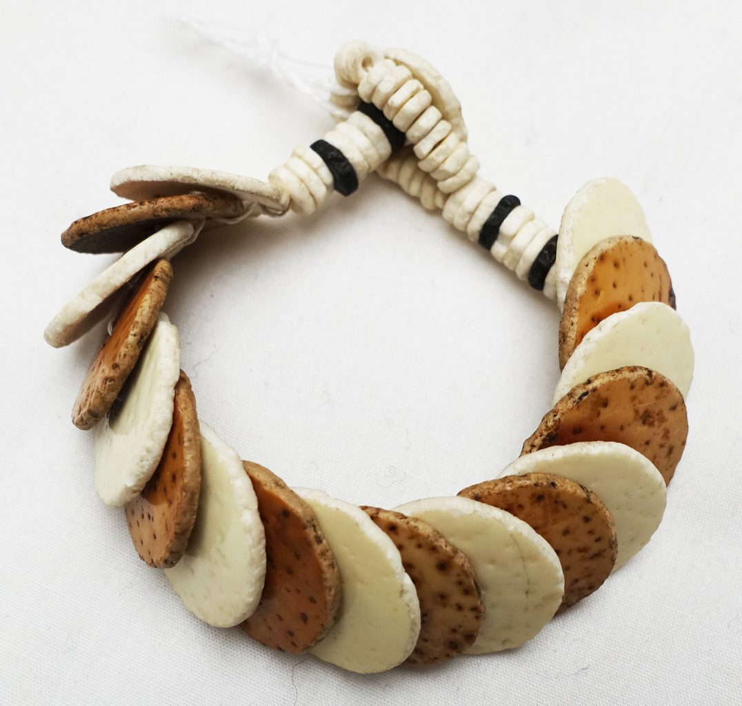 Woman's bracelet made from ostrich shells and cotton (TRC 2022.3117).