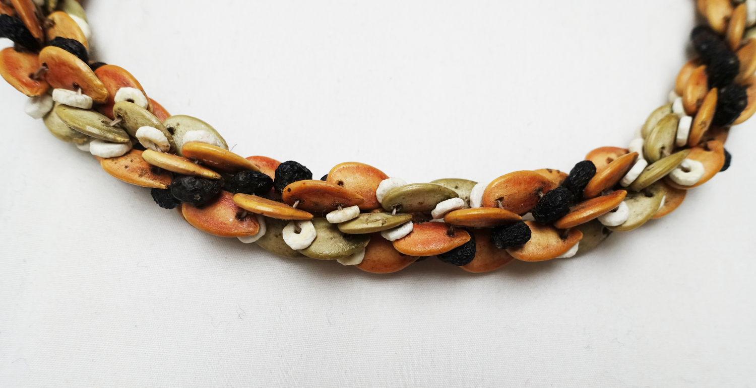 Woman's necklace from Namibia, made from seeds, ostrich shells and cotton (TRC 2022.3118).