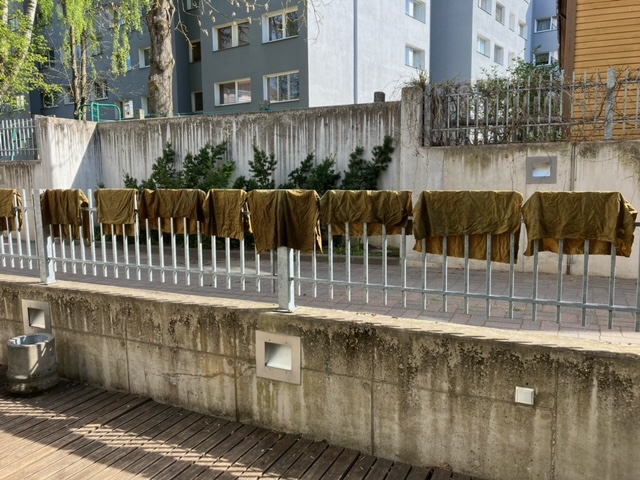 Textiles drying after being dyed in camo colours. University of Tartu, Estonia. 11 May 2023. Photograph by Willlem Vogelsang