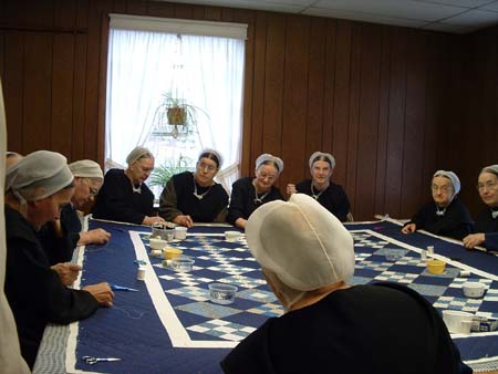 Mennonite women in North America engaged in making quilts, 2005. 