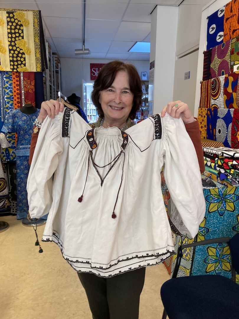 Monique Amsel showing a new donation to the TRC. Romanian Blouse Day, 8 April 2023. Photograph Maria Linkogle.