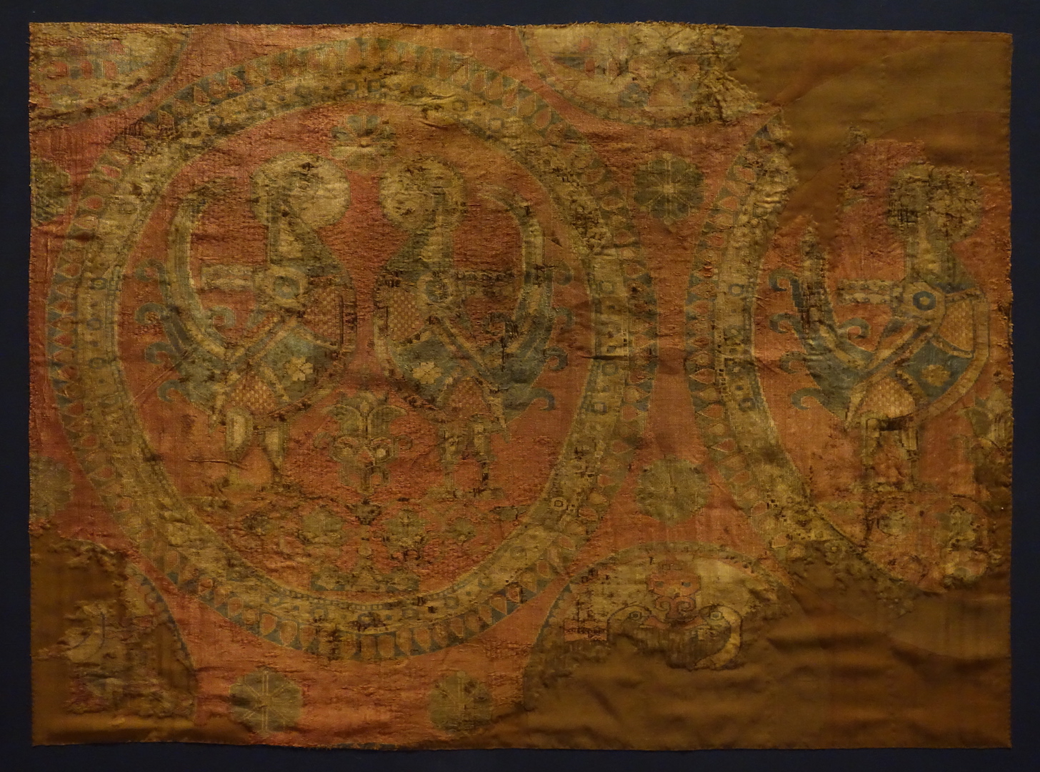 Piece of woven silk with a design of roundels enclosing cockerels. Iranian, 4th/6th century (?)