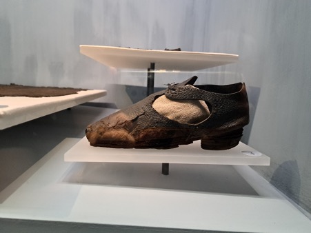 Fig 4: Women’s goatskin shoe. Well mended but of significant style, with decorative stitching and shoe rose. Photograph by author.