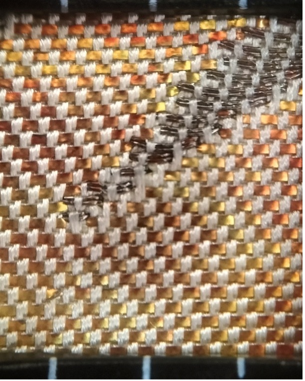Fig. 4: The structure of a hikibaku weave. The weft threads are in silver-grey, the untwisted hikibaku strips are in yellow-orange-brown, and the warp threads are in a cream colour.
