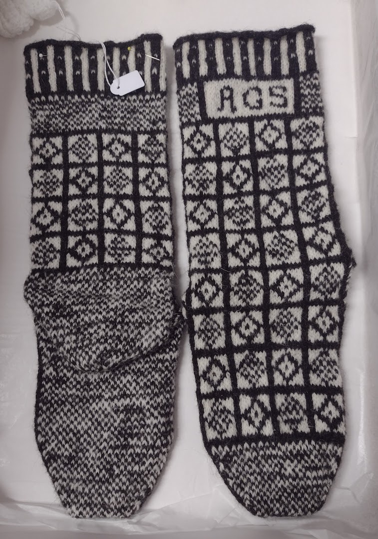 Fig. 2. Hand knitted Sanquhar socks, showing the initials of the wearer (TRC 2019.0274a-b).