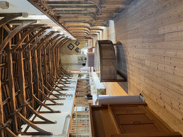 The Victorian-era library, the former monastic dormitory, with the large semi-circular cupboard holding a collection of copes. Durham Cathedral complex. 25 May 2023. Photograph: Willem Vogelsang.