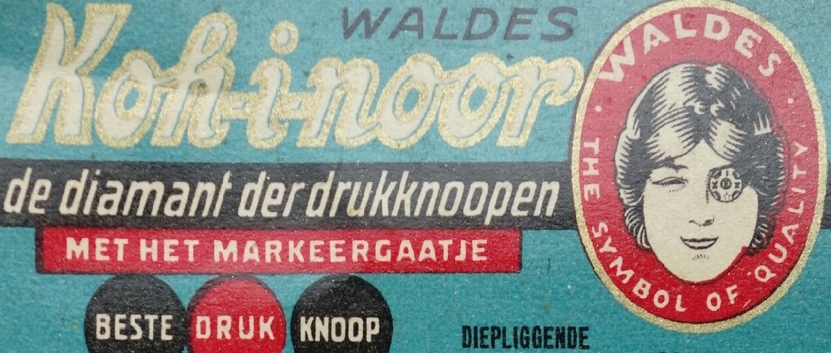 Fig. 4. Detail of a card with six black press studs and the (Dutch) text: "WALDERS Koh-i-noor. De diamant der drukknoopen", with the Koh-i-Noor logo, Miss KIN: a woman with a press stud in her left eye. Produced in Czechia for the Dutch market, before WWII (TRC 2026.2090).