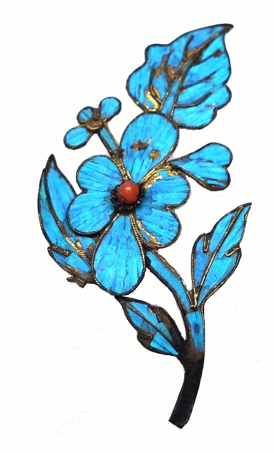 Hairpin from early 20th century China, with a small sprig of flowers and leaves made from gold coloured metal, kingfisher feathers and a coral bead (TRC 2023.2526).