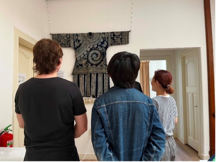 Fig. 7. Visitors exploring the exhibition and learning about Miao textiles through guided tours. Photograph by author.