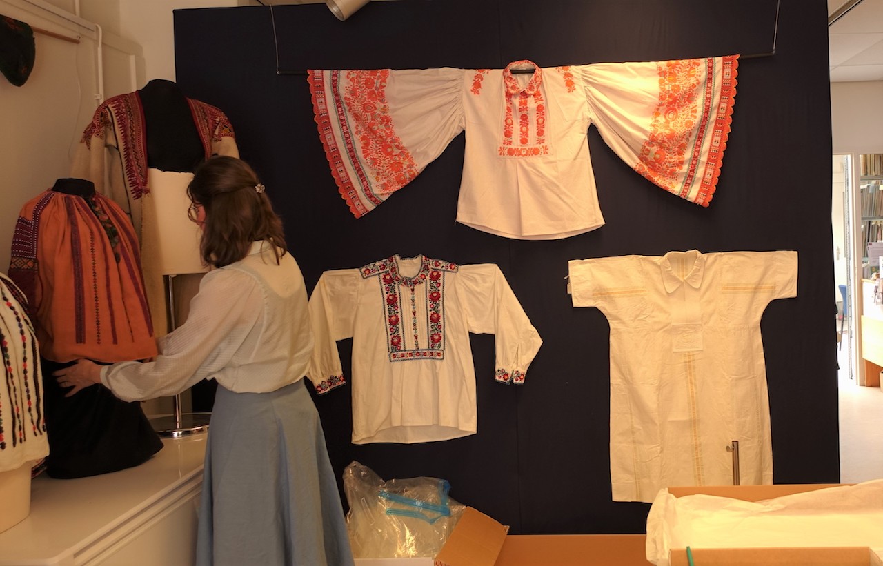 TRC volunteer preparing the pop-up exhibition of East European traditional clothing, for Sunday afternoon 24 April.