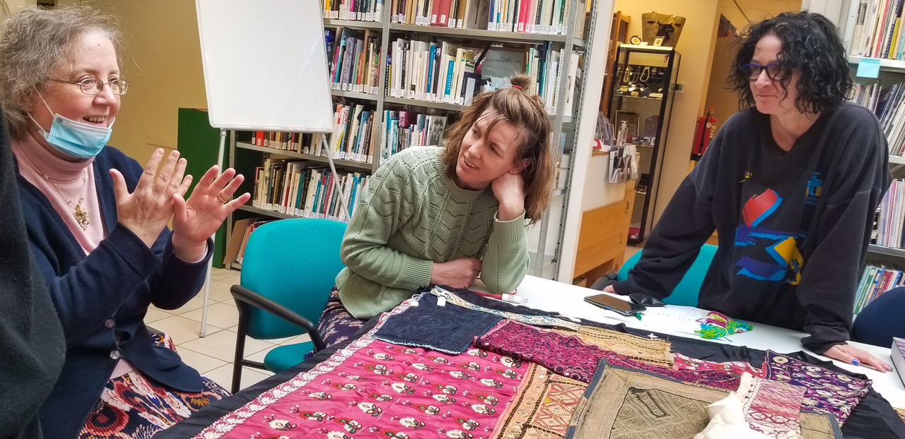 TRC Intensive Textile Course February 2022: Participants studying a variety of textiles, listening to Gillian Vogelsang. Photograph by author.