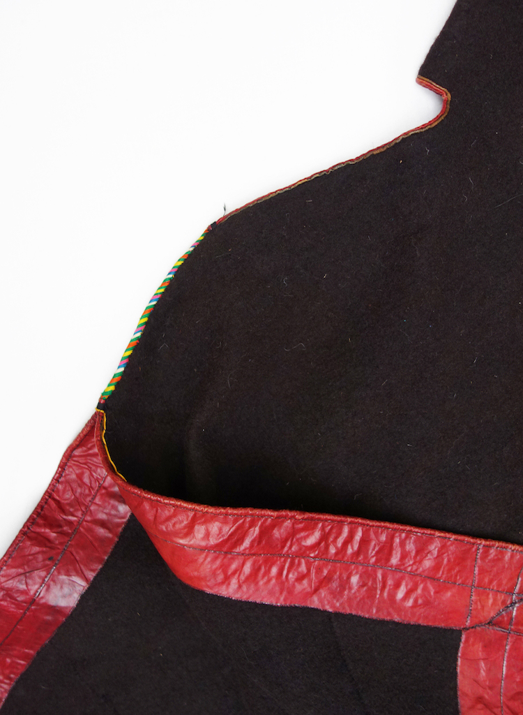 Detail showing the red edging and area of embroidery on the bernos from Debre Berh, central Ethiopia (TRC 2021.0814).