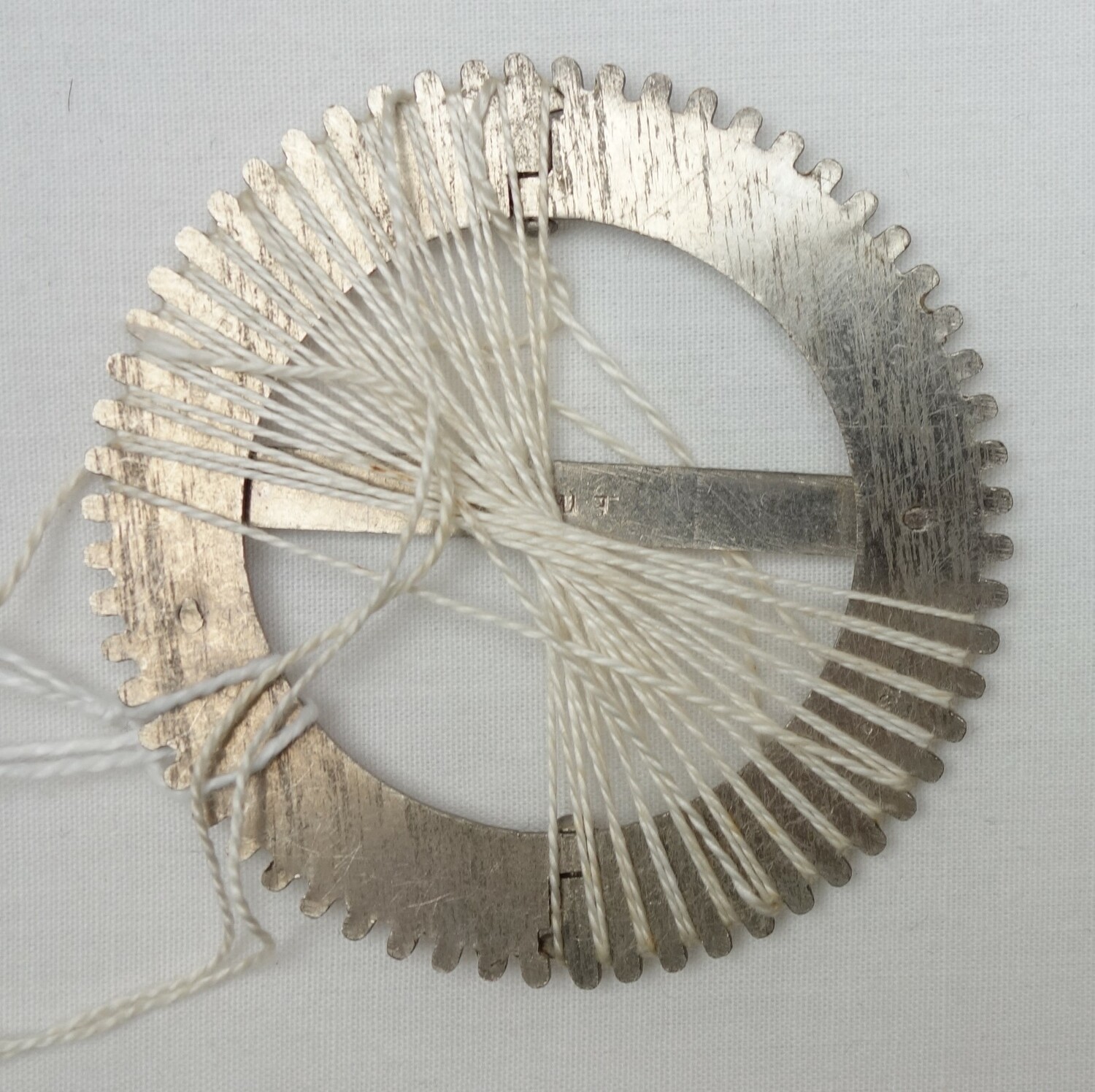 Tenerife lace metal wheel, with radial threads, early 20th century (TRC 2023.2316b).