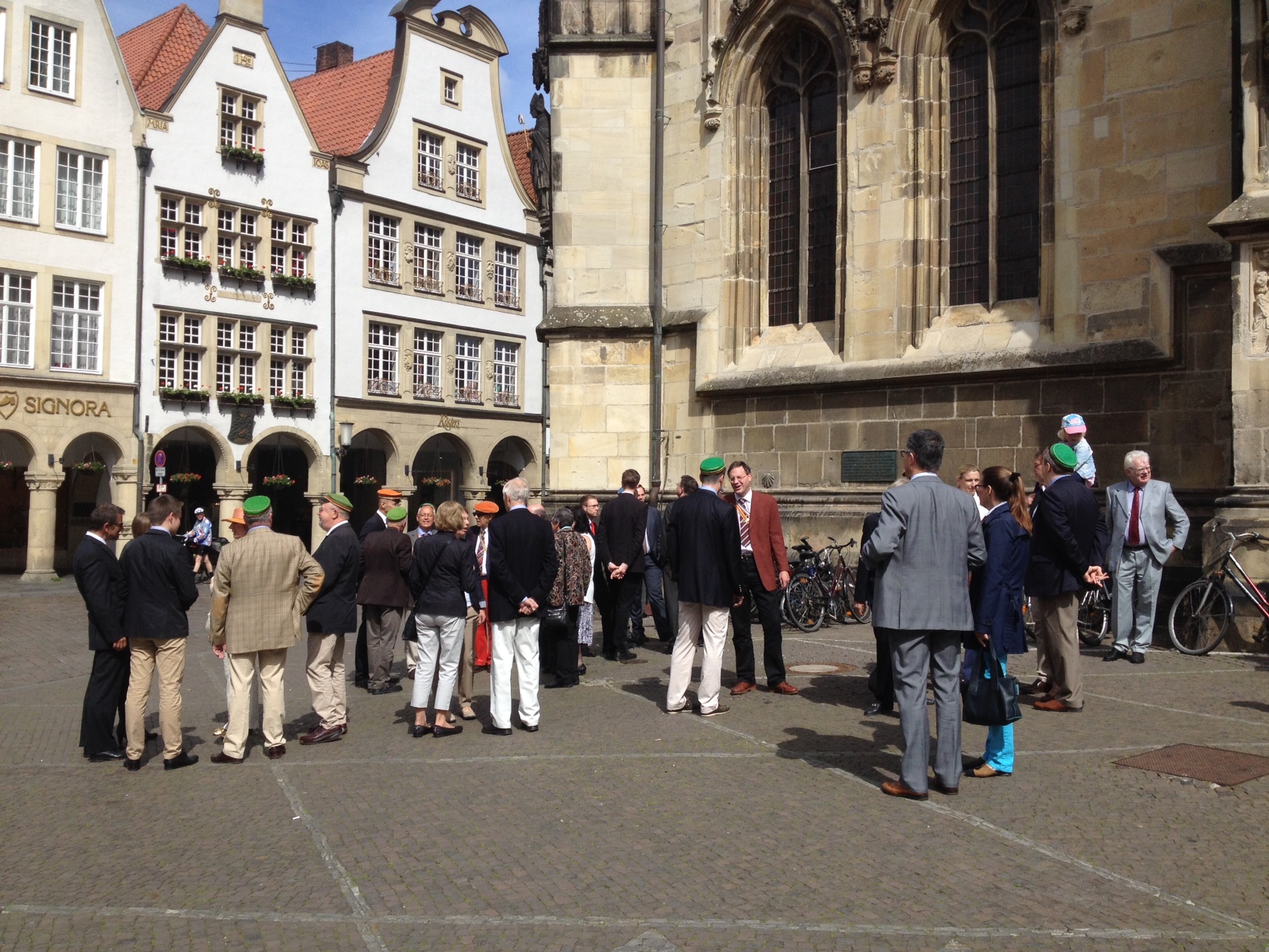 Group of (ex)students with their Mütze (cap) in front of the Lambertikirche, Münster, Germany, 24 May 2015