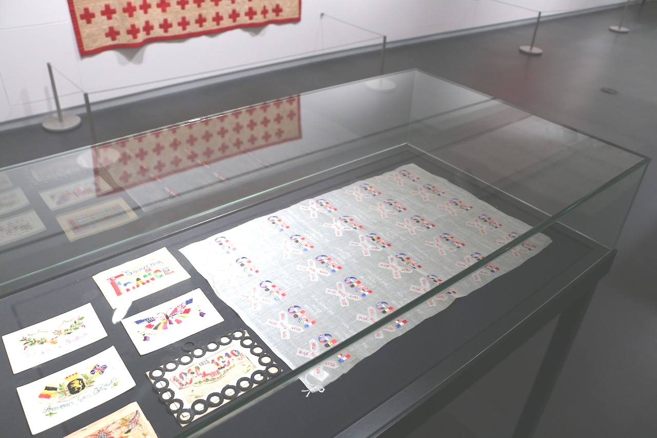 TRC sheet of embroidered designs for WW1 postcards, on display in Kansas City (TRC 2015.0422).