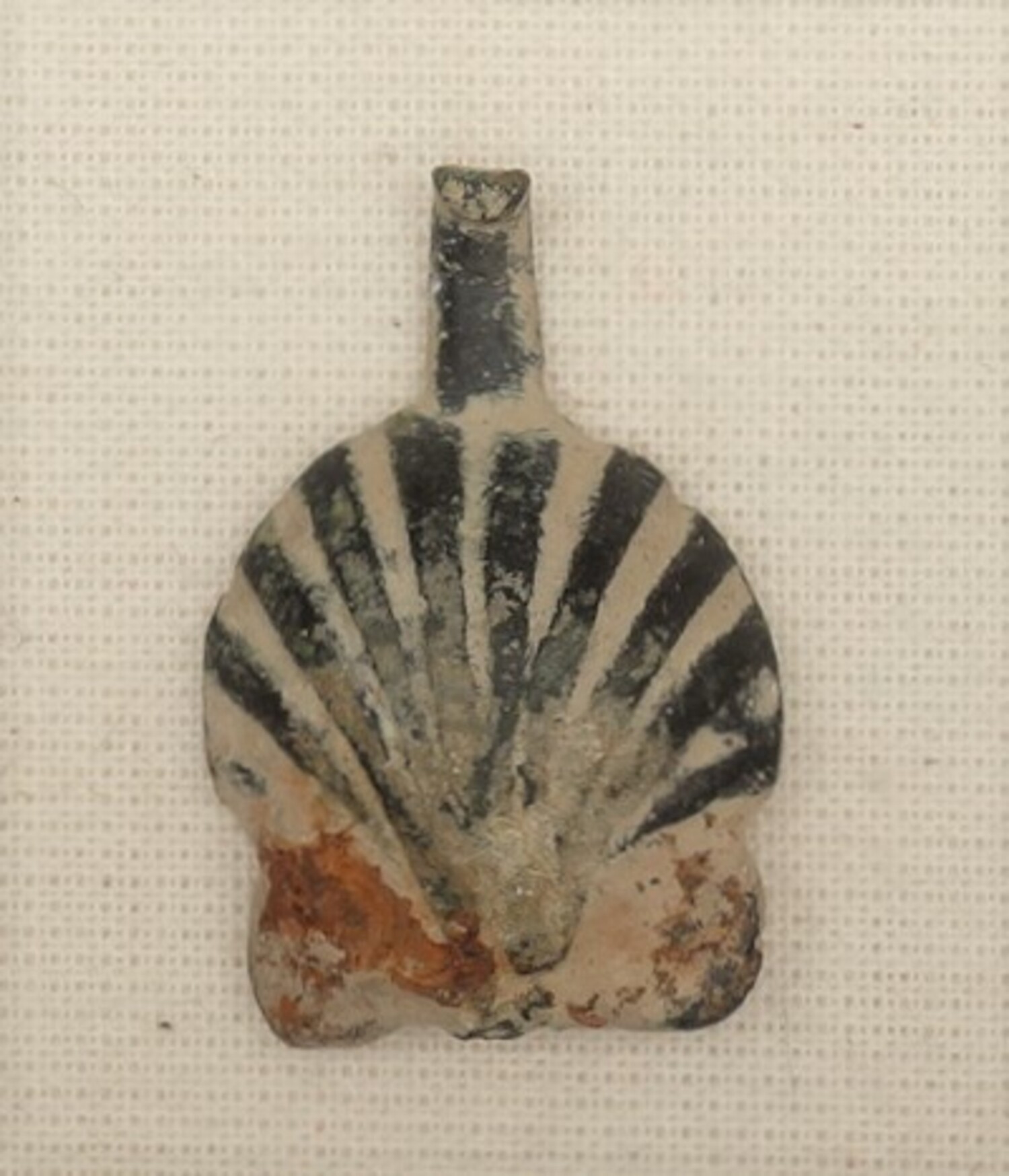 Medieval scallop shell badge for a pilgrim to Santiago de Compostela (TRC 2020.3387).