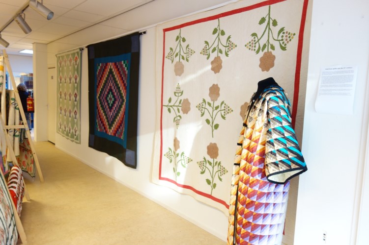 Three historic quilts from 1916 (left), late 19th century (centre), and 1840's (right). The appliqué coat was made in early 21st century by Henny Vogelsang from Schagen, The Netherlands.