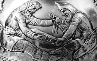 Detail of the golden vase illustrated above (not the same scene as above). The two Scythians depicted have the characteristic long hair and beard. One of them has a high pointed cap. They both wear trousers and a tunic.