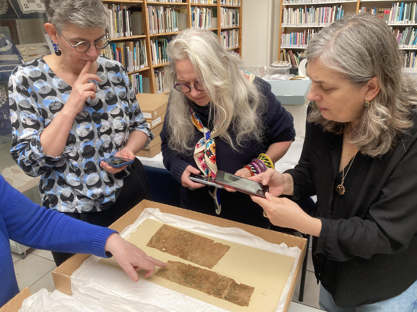 Polish delegation studies Byzantine-period fragments of embroidery from 6th/7th century AD, Egypt, from the TRC collection.