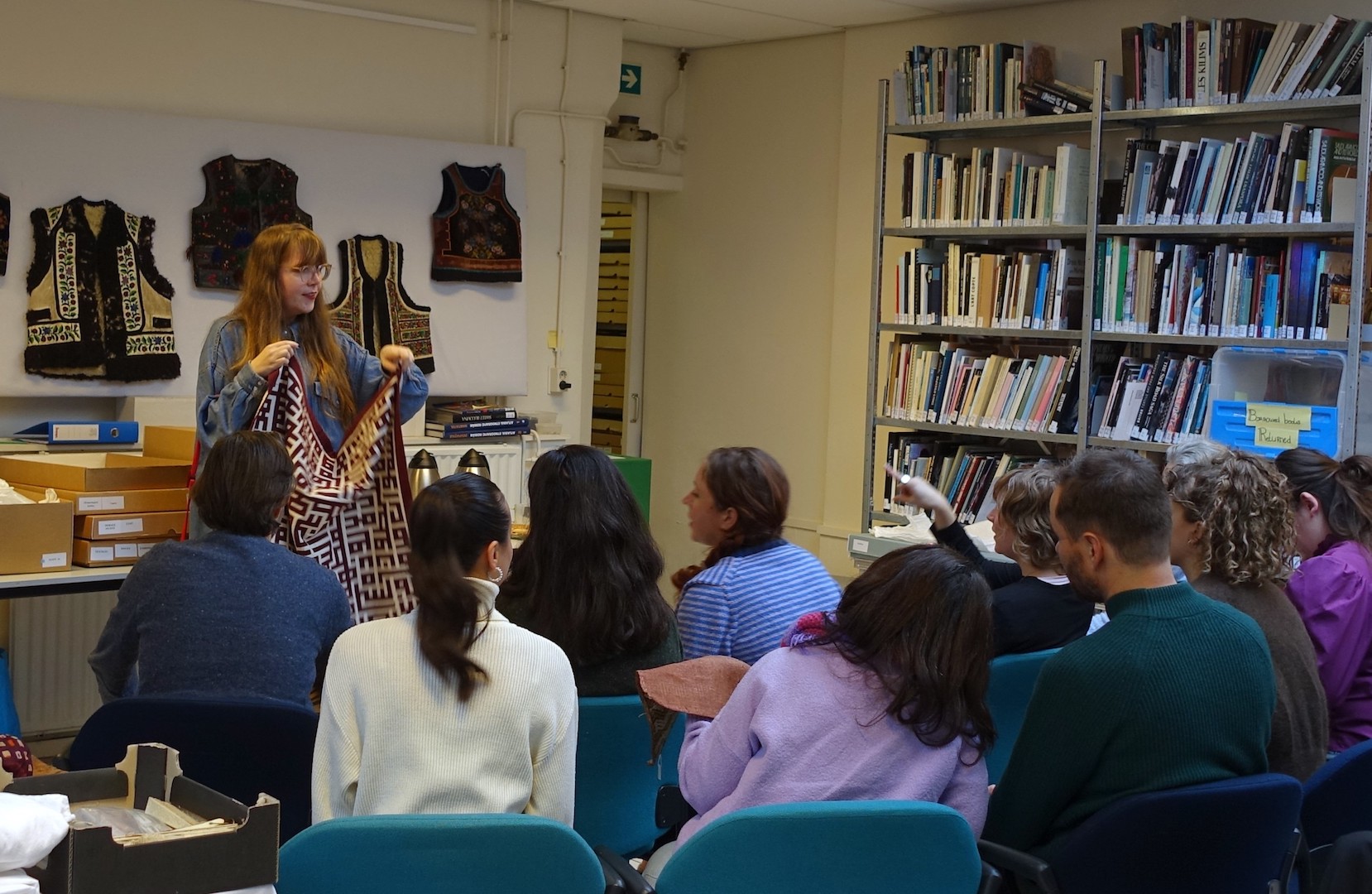 Christina de Korte, TRC intern, talking with a team from the textile printing firm of Vlisco visiting the TRC, Tuesday 3 December 2024. Photograph by TRC. 